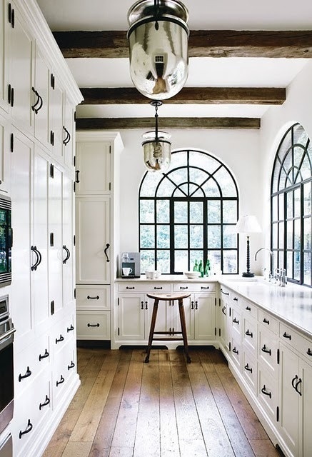 Black and white kitchen with exposed beams