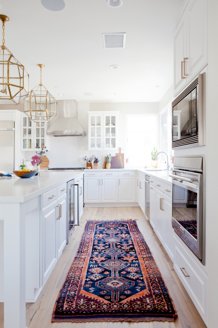 White kitchen with vintage rug