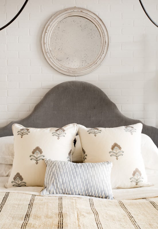 Grey headboard with neutral pillows