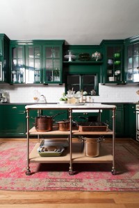 green kitchen with a pink vintage rug