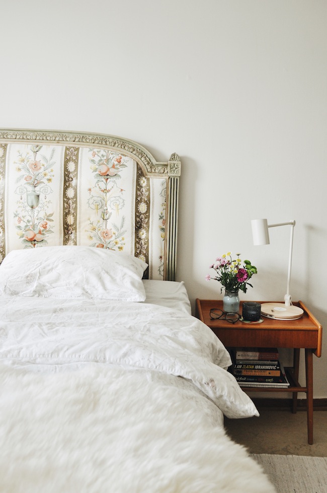 White bedroom with vintage headboard